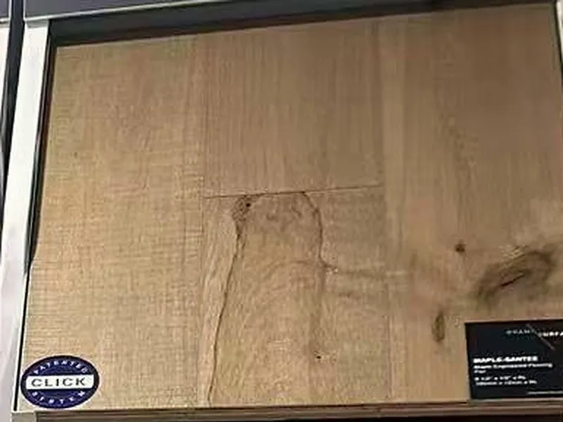 CS engineered maple flooring sample with a click-system badge.
