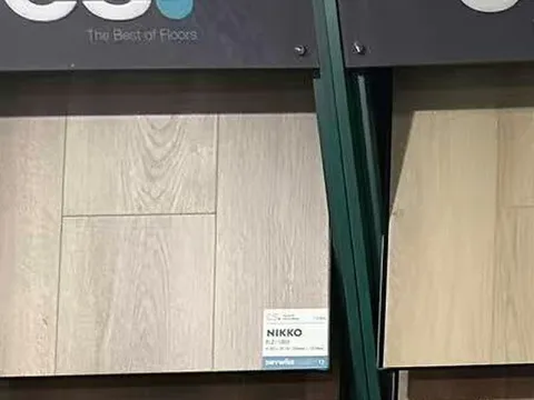 CS Drywise and Drycraft flooring samples on green display racks.